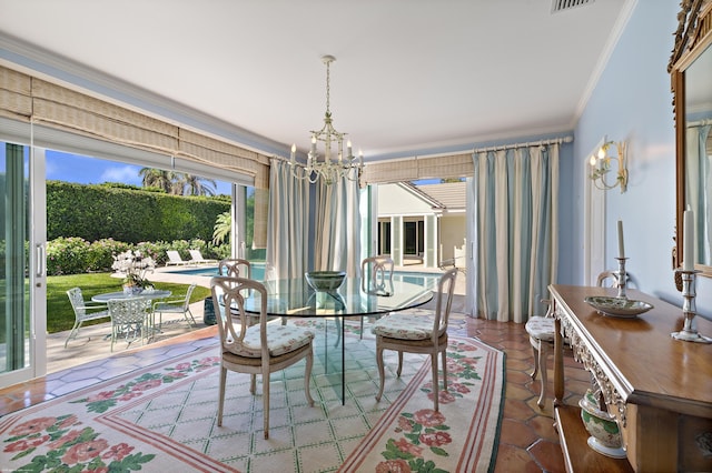 dining area featuring a notable chandelier, ornamental molding, and tile patterned flooring