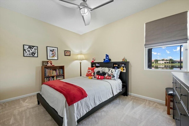 bedroom featuring light colored carpet and ceiling fan