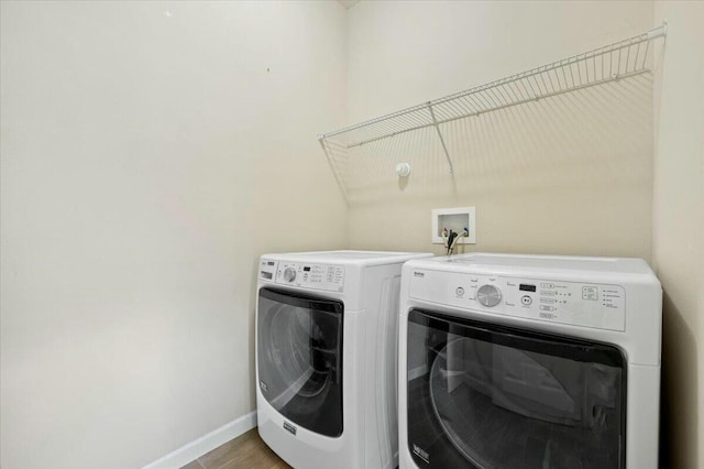 washroom featuring separate washer and dryer and light wood-type flooring