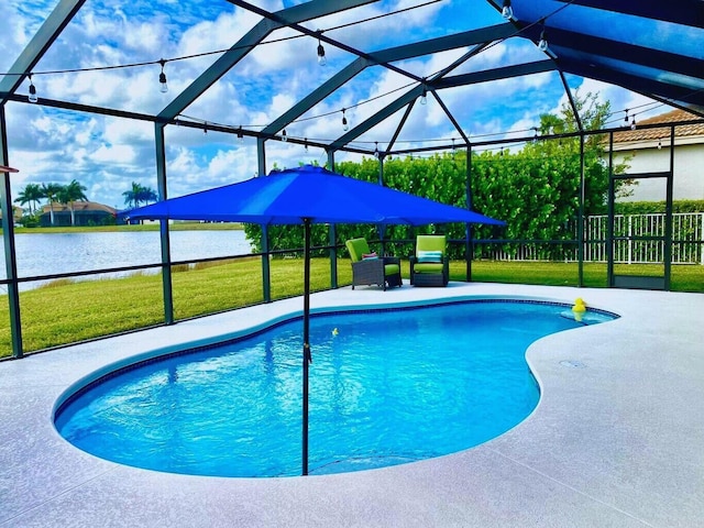 view of pool featuring a water view, a patio, glass enclosure, and a lawn