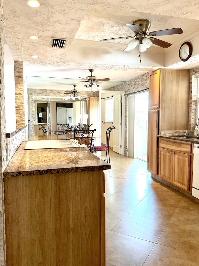 kitchen featuring white appliances, ceiling fan, and sink