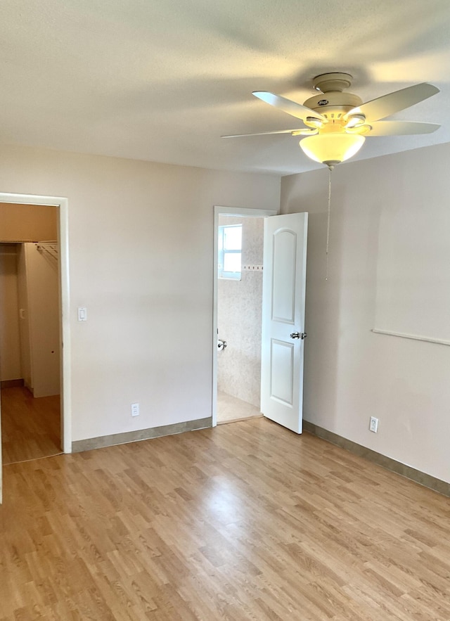 unfurnished room with ceiling fan and light wood-type flooring