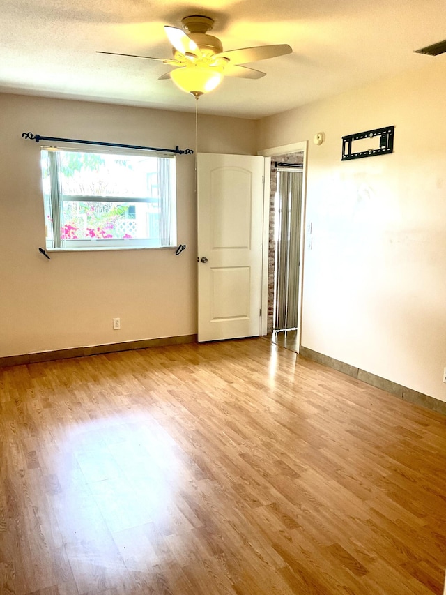 unfurnished room featuring ceiling fan and light hardwood / wood-style floors