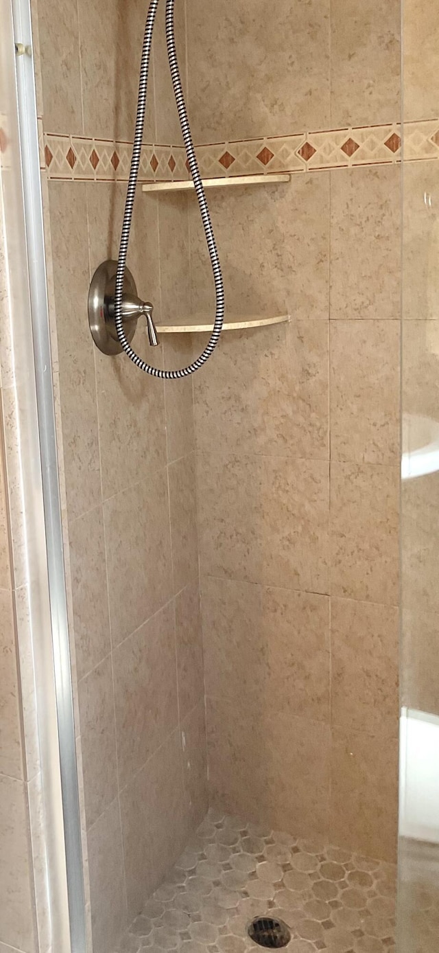 bathroom with tiled shower