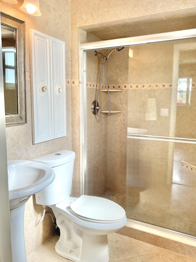 bathroom with toilet, an enclosed shower, and tile patterned flooring