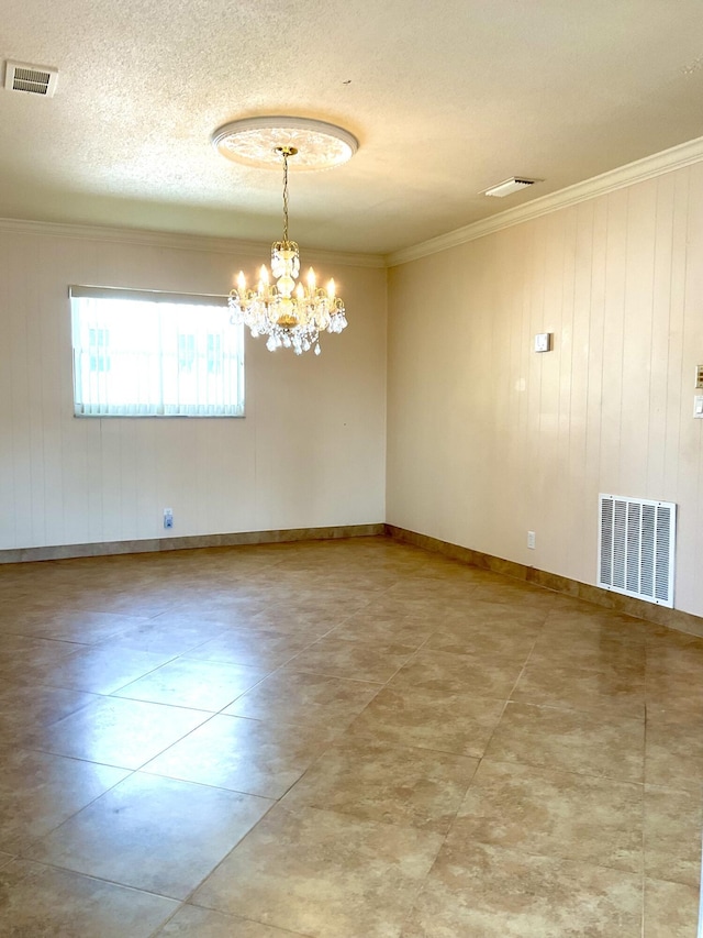 spare room with an inviting chandelier, crown molding, and a textured ceiling