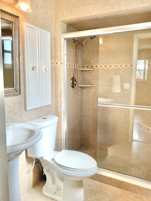 bathroom with tile patterned flooring, a stall shower, and toilet