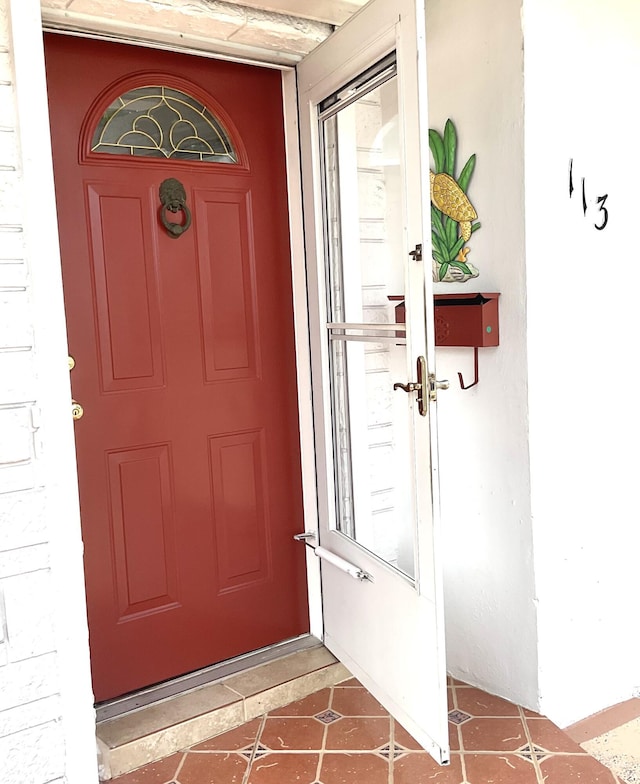 view of exterior entry with stucco siding