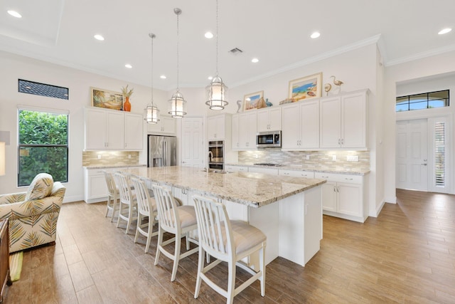 kitchen with white cabinetry, a spacious island, and appliances with stainless steel finishes