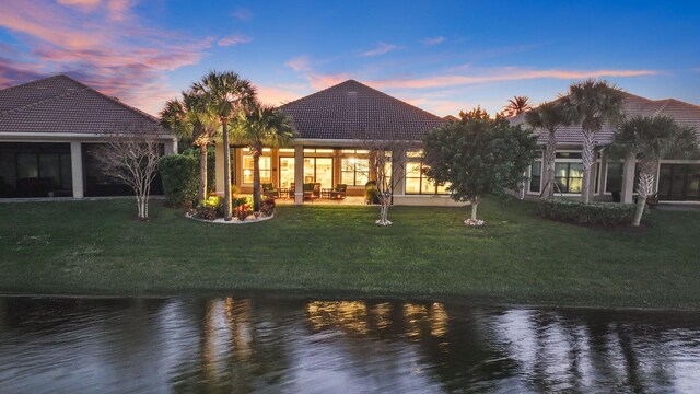 view of patio with ceiling fan, a water view, and grilling area