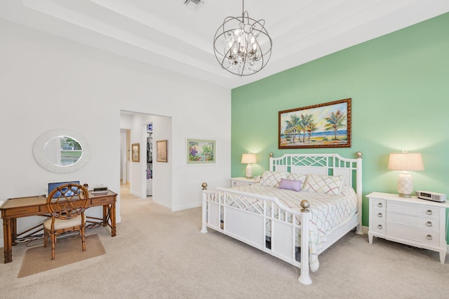 bedroom featuring a raised ceiling, light colored carpet, and a chandelier