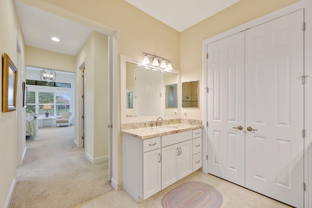 bathroom with vanity and an inviting chandelier