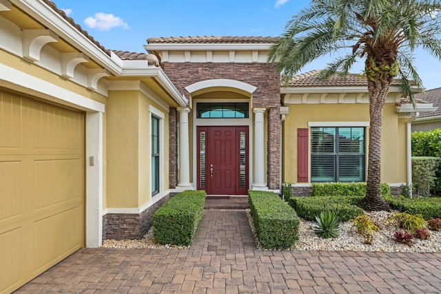 view of exterior entry featuring a garage