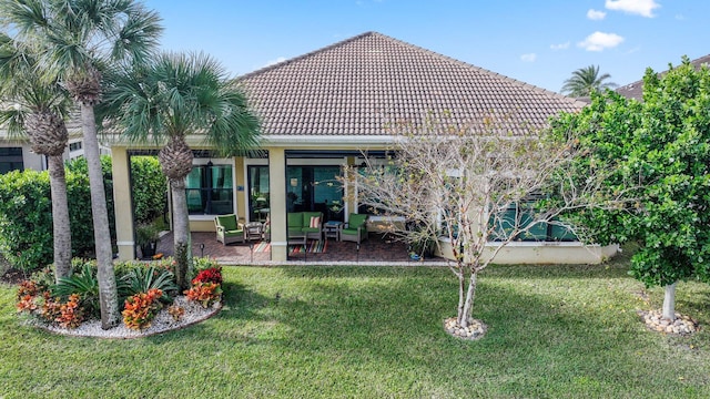 rear view of house with a patio and a lawn