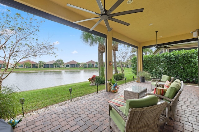 view of patio / terrace with a water view and ceiling fan