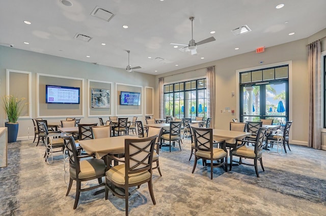 dining area featuring ceiling fan and concrete floors