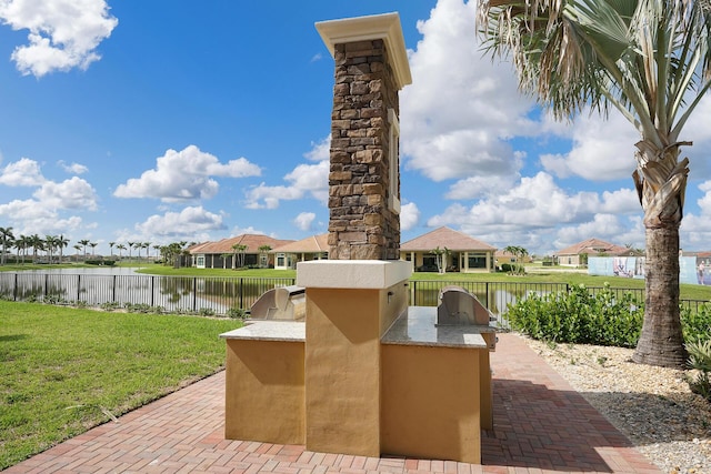 view of patio / terrace with a water view and area for grilling