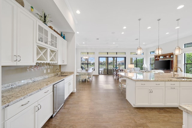 kitchen featuring white cabinetry, sink, and dishwasher