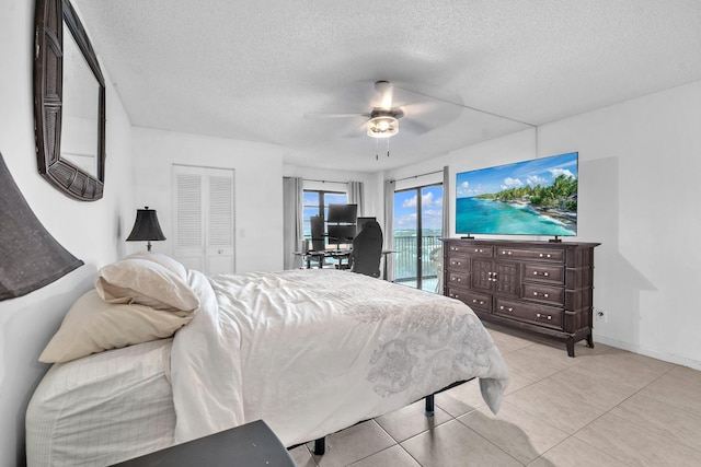 bedroom featuring ceiling fan, access to exterior, a closet, and a textured ceiling