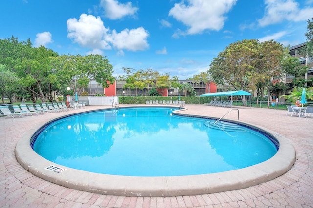 view of swimming pool with a patio area