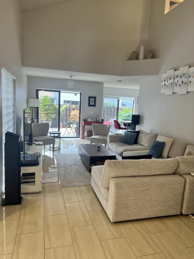 living room featuring a high ceiling and light tile patterned flooring