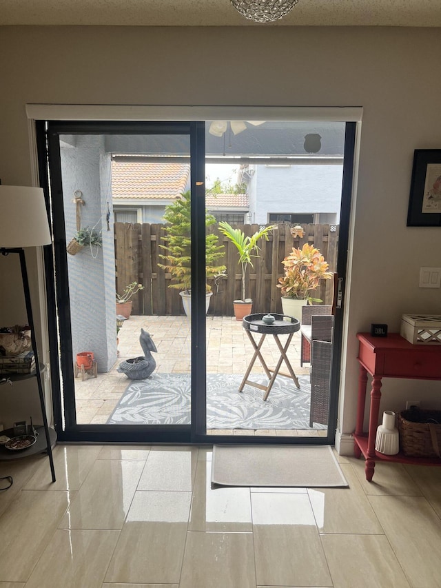 doorway to outside with tile patterned flooring