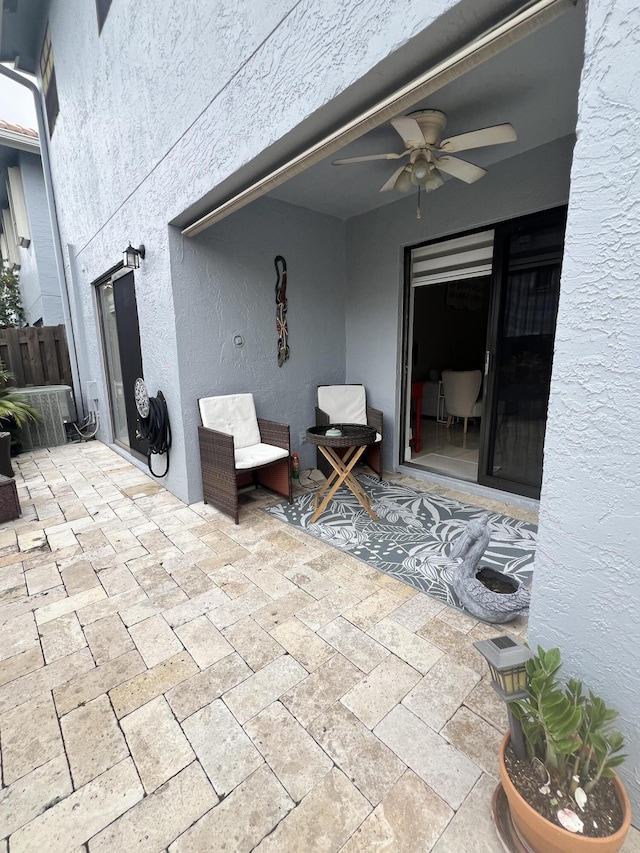 view of patio featuring ceiling fan