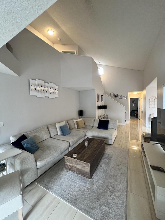 tiled living room featuring vaulted ceiling