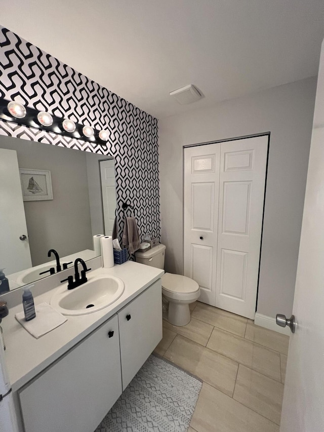 bathroom featuring toilet and vanity