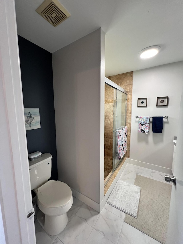 bathroom with toilet and a shower with door