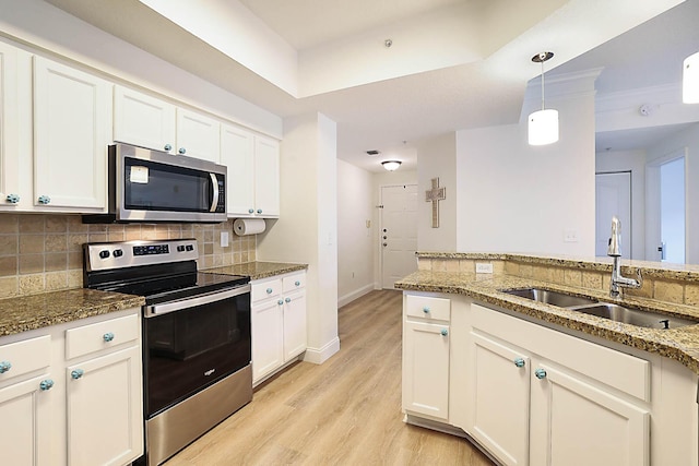 kitchen featuring sink, white cabinets, stone counters, and stainless steel appliances