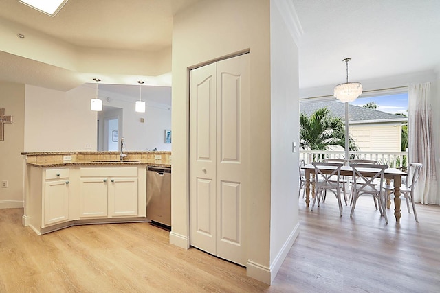 kitchen with dishwasher, decorative light fixtures, white cabinetry, sink, and light wood-type flooring