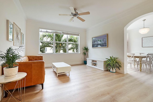 sitting room featuring ceiling fan with notable chandelier, light hardwood / wood-style flooring, and crown molding