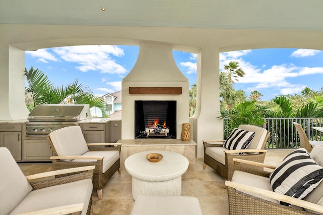 view of patio with a tiled fireplace and area for grilling