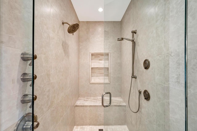 bathroom featuring a shower with shower door