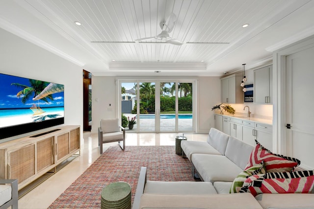 living room with ceiling fan, wood ceiling, and a raised ceiling