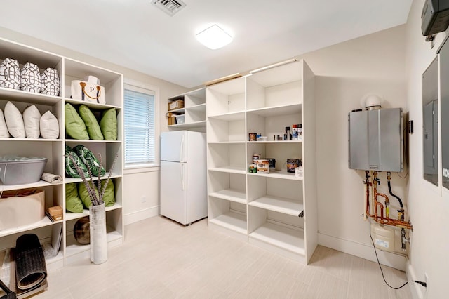 miscellaneous room featuring electric panel and water heater