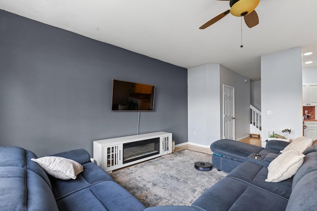 living room featuring ceiling fan and tile patterned floors