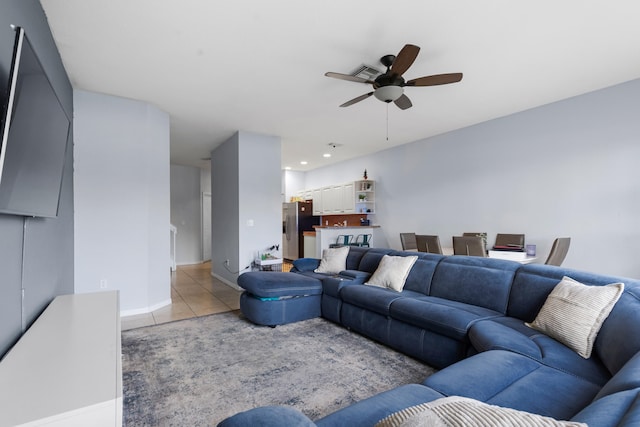 living room with light tile patterned floors and ceiling fan