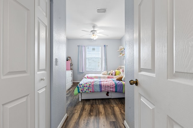 bedroom featuring ceiling fan and dark hardwood / wood-style flooring