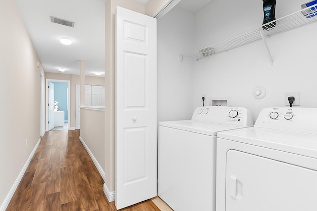 5138 White Oleander, West Palm Beach, FL 33415 - washroom with washing machine and dryer, wood finished floors, and baseboards