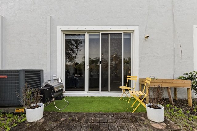 doorway to property with central AC unit