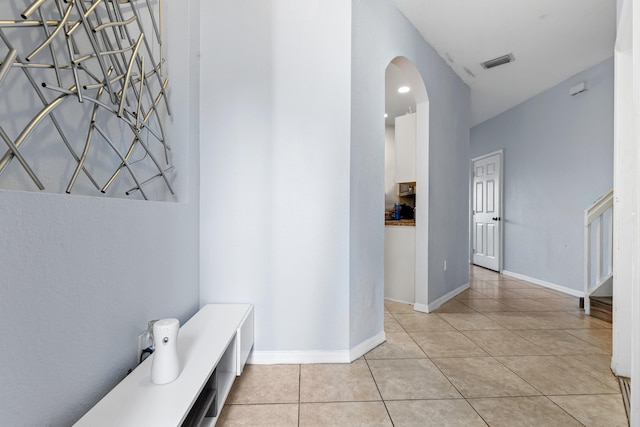 hallway featuring light tile patterned floors