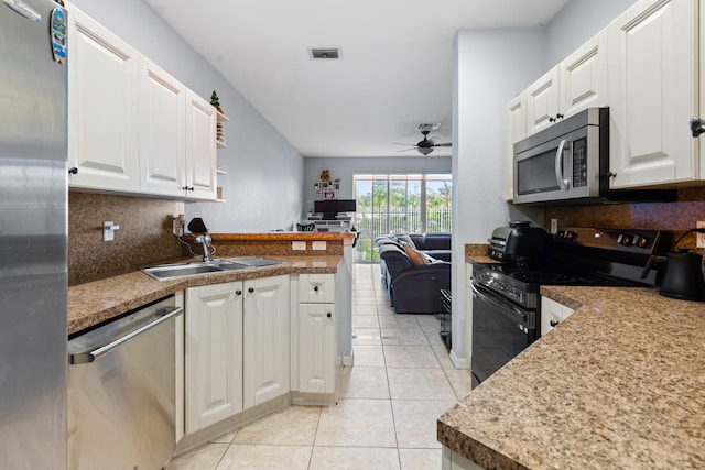 kitchen with white cabinetry, sink, light tile patterned flooring, and appliances with stainless steel finishes