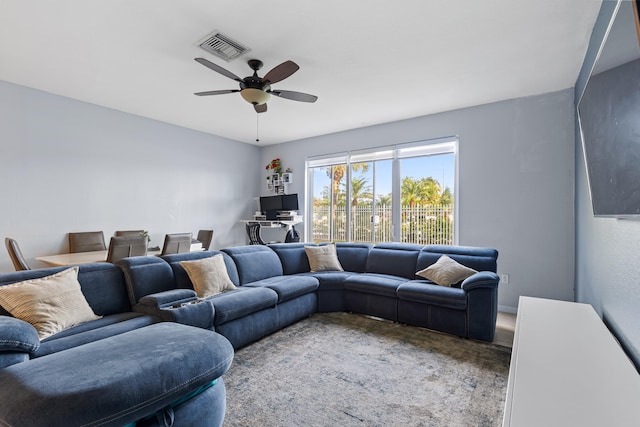 carpeted living room featuring ceiling fan