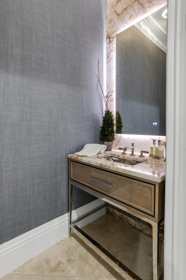 bathroom with ornamental molding, vanity, and tile patterned flooring