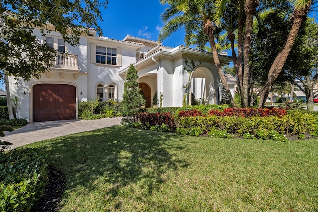 mediterranean / spanish-style house with a balcony and a front lawn