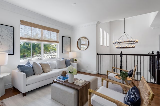 living room with light wood-type flooring and a notable chandelier