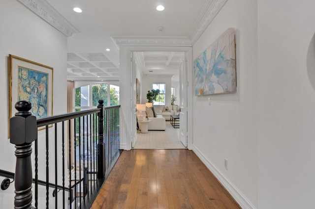 corridor with hardwood / wood-style flooring, ornamental molding, coffered ceiling, and beamed ceiling