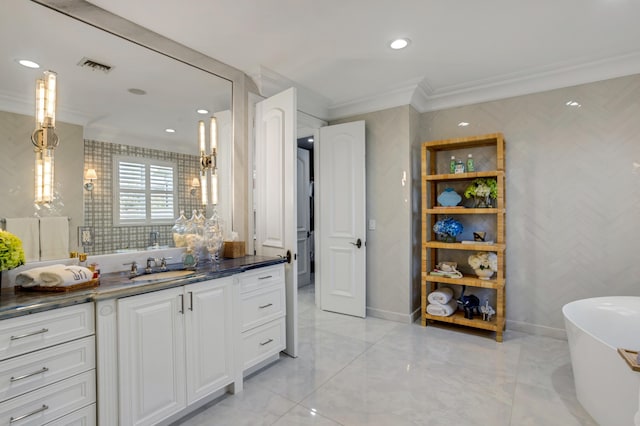 bathroom with vanity, a bath, and crown molding